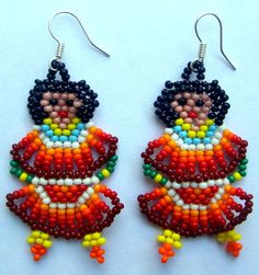 two pairs of beaded earrings with colorful beads on the bottom and one is wearing a red