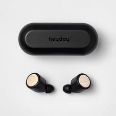 the headphones are next to each other on a white surface with black and gold earbuds