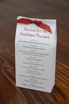 a survival kit for healthcare caregivers on a wooden table with a red ribbon