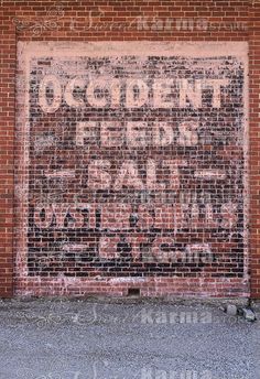 an old sign on the side of a brick building