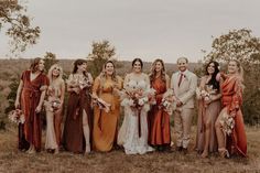 a group of people standing next to each other on top of a grass covered field