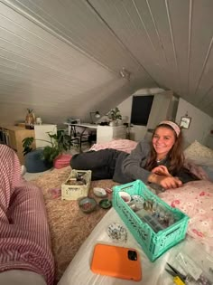 a woman laying on top of a bed in a loft next to other furniture and accessories