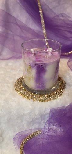 a candle that is sitting on some kind of cloth with a bead around it