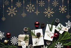 christmas presents and pine cones on a dark background with snowflakes, ornaments and baubles