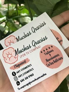 a person holding up two business cards for munchs craises potty company