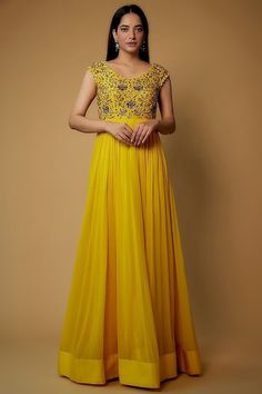 Featuring a yellow dress in dola silk, cotton, shantoon, and georgette base with embroidery. Perfect wear for festive occasions. This product will be shipped to you after 1-2 weeks from the date of order placed. All custom made orders are not returnable. Pls contact for Size chart and for other more colors Request You :To provide contact details for courier services. {VARIATION MAY COME DEPENDING UPON AVALIBILITY OF LACES OR GOTTA PATI or TUSSELS} NOTE:  1) Visual Samples on website may differ slightly from actual product due to light & effects during photography (Length & Breadth have 1 n 1.5 inches +/-). 2) Before placing order ,pls confirm product n color availability and  For Wholesale Order MOQ is 5 Pieces of any color/Pattern on +91 7903893945 & +91 8447750028(WhatsApp) Bridal lehang Designer Yellow Anarkali Set With Chikankari Embroidery, Yellow Anarkali Set With Chikankari Embroidery For Designer Wear, Yellow Embroidered Anarkali Set In Georgette, Yellow Georgette Anarkali Set With Zari Work, Yellow Georgette Anarkali Saree Set, Yellow Georgette Anarkali Set Bollywood Style, Yellow Georgette Anarkali Set For Diwali, Yellow Dori Work Dress For Reception, Georgette Embroidered Dress For Reception And Festivals