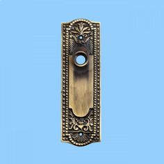 an ornate brass door handle on a blue background