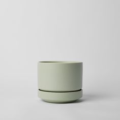 two white bowls sitting on top of each other