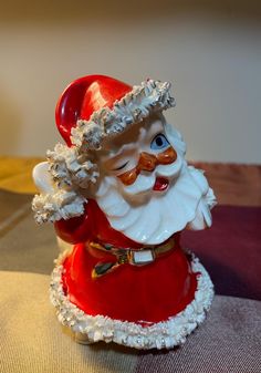 a santa clause figurine sitting on top of a table