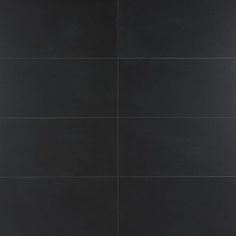 a black tile wall with white lines on the bottom and one line at the top