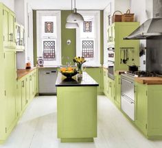 a kitchen with lime green cabinets and white counter tops, along with an island in the middle