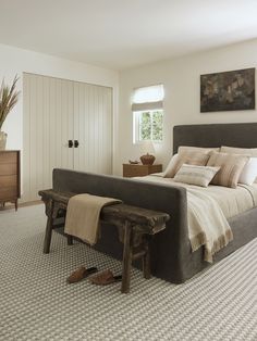 a bedroom with a large bed and wooden furniture in it's centerpieces