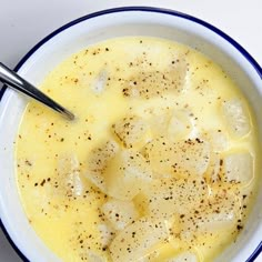 a bowl filled with soup on top of a white table