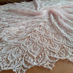 a white crocheted doily on a wooden table