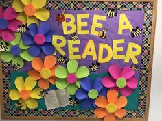 a bulletin board with paper flowers and bees on it that says, bee a reader