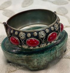 "Vintage Italian Alpaca Silver Bracelet with red Cabochons Mid-Century marked. Beautiful silver alloy bracelet with floral motif. Dates to mid-century Italy. Marked \"MADE IN ITALY\" and \"ALP\" for alpaca silver, an alloy with low silver content. Bracelet closes with a sliding bar clasp. Great condition. Measures 8 inches around and 1 1/4 inch wide." Vintage Cabochon Bangle Jewelry, Vintage Red Adjustable Bracelets, Vintage Adjustable Red Bracelets, Vintage Red Adjustable Bracelet, Vintage Red Round Jewelry, Ornate Red Cabochon Jewelry, Formal Red Metal Bracelets, Vintage Cabochon Bracelets, Vintage Cabochon Bangle Bracelets