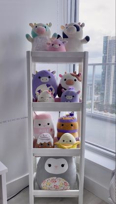 a shelf with stuffed animals on top of it