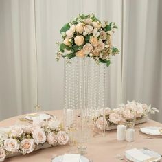 a table with flowers and place settings on it for a formal dinner or wedding reception