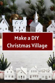 a christmas village with white houses and evergreens on the mantle in front of it