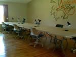 an empty conference room with tables and chairs