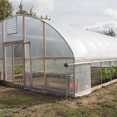 a small greenhouse with several plants growing inside