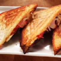 four slices of toasted sandwich on a white plate