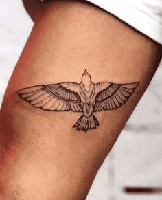 a small bird tattoo on the leg