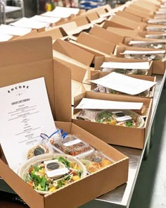 several boxes filled with food sitting on top of a counter