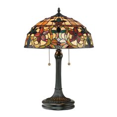 a table lamp with a stained glass shade on it's base and beaded cord