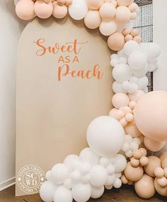 an arch made out of balloons with the words sweet as a peach on it