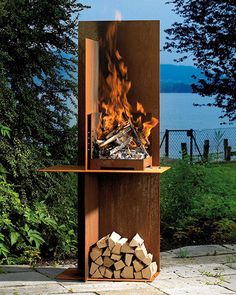 an outdoor fireplace with logs and firewood