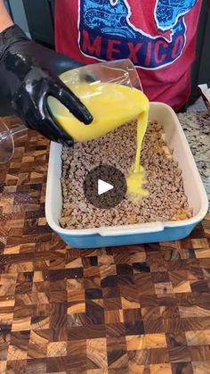 a person pouring yellow liquid into a bowl