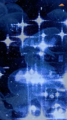 an abstract blue and white photo with stars in the sky above it, on a black background