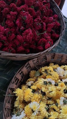 two baskets filled with yellow and red flowers