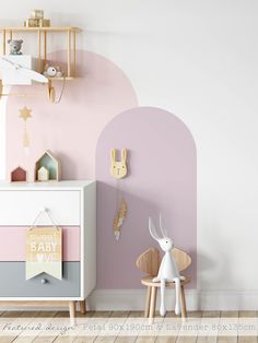 a baby's room with pink and white walls, wooden furniture and toys on the floor