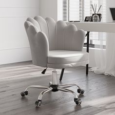 a white office chair sitting on top of a hard wood floor