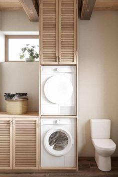 a washer and dryer are stacked on top of each other in the bathroom