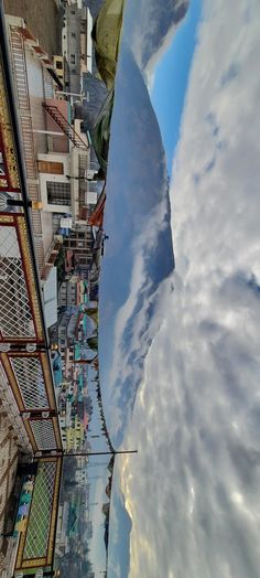 the sky is reflected in the water next to buildings