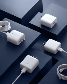 four different types of cords and plugs connected to each other on top of blue surface