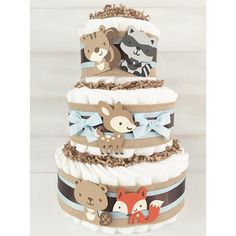 a three tiered diaper cake with woodland animals on the top and blue ribbon