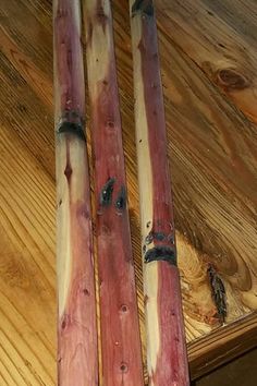 two wooden skis sitting on top of a wooden floor