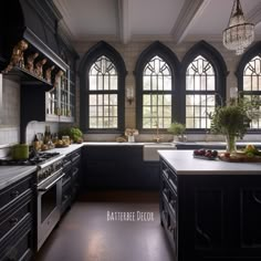 a large kitchen with black cabinets and white counter tops