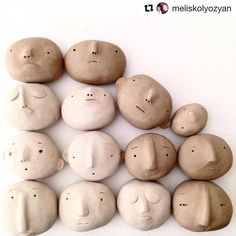 a group of rocks with faces drawn on them, all in different shapes and sizes