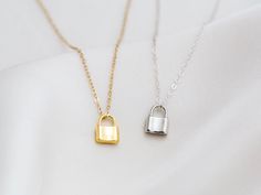 "Dainty lock necklace! The pendant is made of gold vermeil, which is heavy gold plating over sterling silver. Pair it with your favorite outfit! Layer with other necklaces, by or wear itself for a pop! . . . . . . . . . . . . . . . . . . . . . . . . . . . . . . . . . . . . . . . . . . NECKLACE + Length: 16\" + 2\" extender + Vermeil (18k gold plating over sterling silver) -or- sterling silver lock pendant: 8mm x 11mm + 14k gold filled -or- sterling silver chain, spring clasp, & findings LAYE Silver Lock Necklace Gift, Silver Necklace With Lock Gift, Silver Necklace With Lock As Gift, Everyday Gold Lock Jewelry, Everyday Gold Jewelry With Lock Detail, Silver Chain Necklace With Lock For Gifting, Silver Lock Chain Necklace As A Gift, Gold Lock Necklace As Gift, Silver Chain Necklace With Lock For Gift