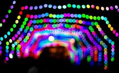 colorful lights in the dark with blurry colors on them and an image of a tunnel