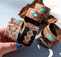 Hand Tooled Leather Cuff Bracelets These are all one-of-a-kind, slowly hand tooled in my workshop and hand painted with great detail!  A rugged and weathered finish adds a dash of Western Boho to your outfit! The turquoise focal points are painted to look like a chunk of turquoise stone.  Each bracelet was slowly made entirely by hand.  This means each and every bracelet will have slight differences because they're handmade, not machine made! These are ready to ship! These cuffs features Top Qua Luxury Hand Tooled Brown Bracelet, Luxury Southwestern Stamped Cuff Bracelet, Cactus Bracelet, Boho Leather Jewelry, Leather Cuff Bracelets, Custom Leather Work, Leather Wrist Cuff, Western Bracelets, Leather Jewelry Diy