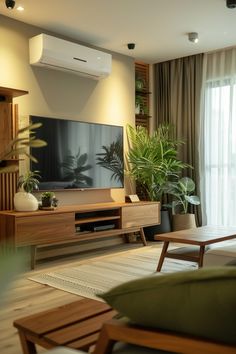 a living room filled with furniture and a flat screen tv on top of a wooden entertainment center