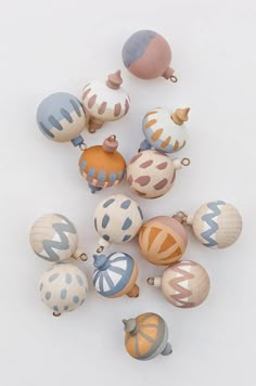 a bunch of different colored ornaments on a white surface