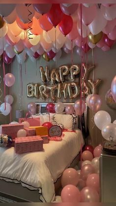 a bedroom decorated with balloons and gifts for a birthday or other special occasion to celebrate