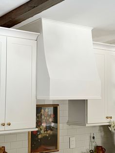 a kitchen with white cabinets and an oven